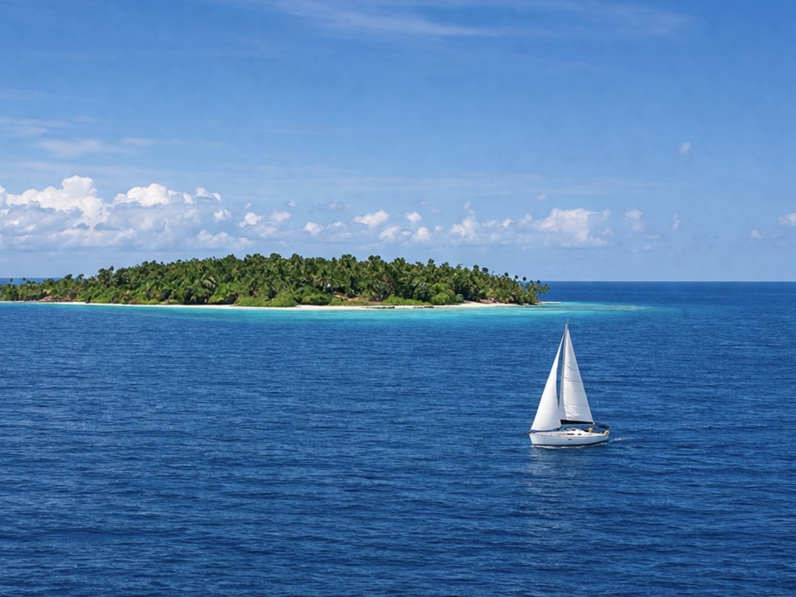 Bavaria 35 sailboat sailing between tropical islands in San Blas archipelago Guna Yala Panama