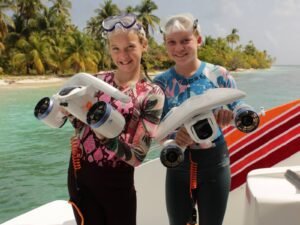 Happy guests holding snorkel gear on catamaran deck in San Blas Islands Guna Yala Panama
