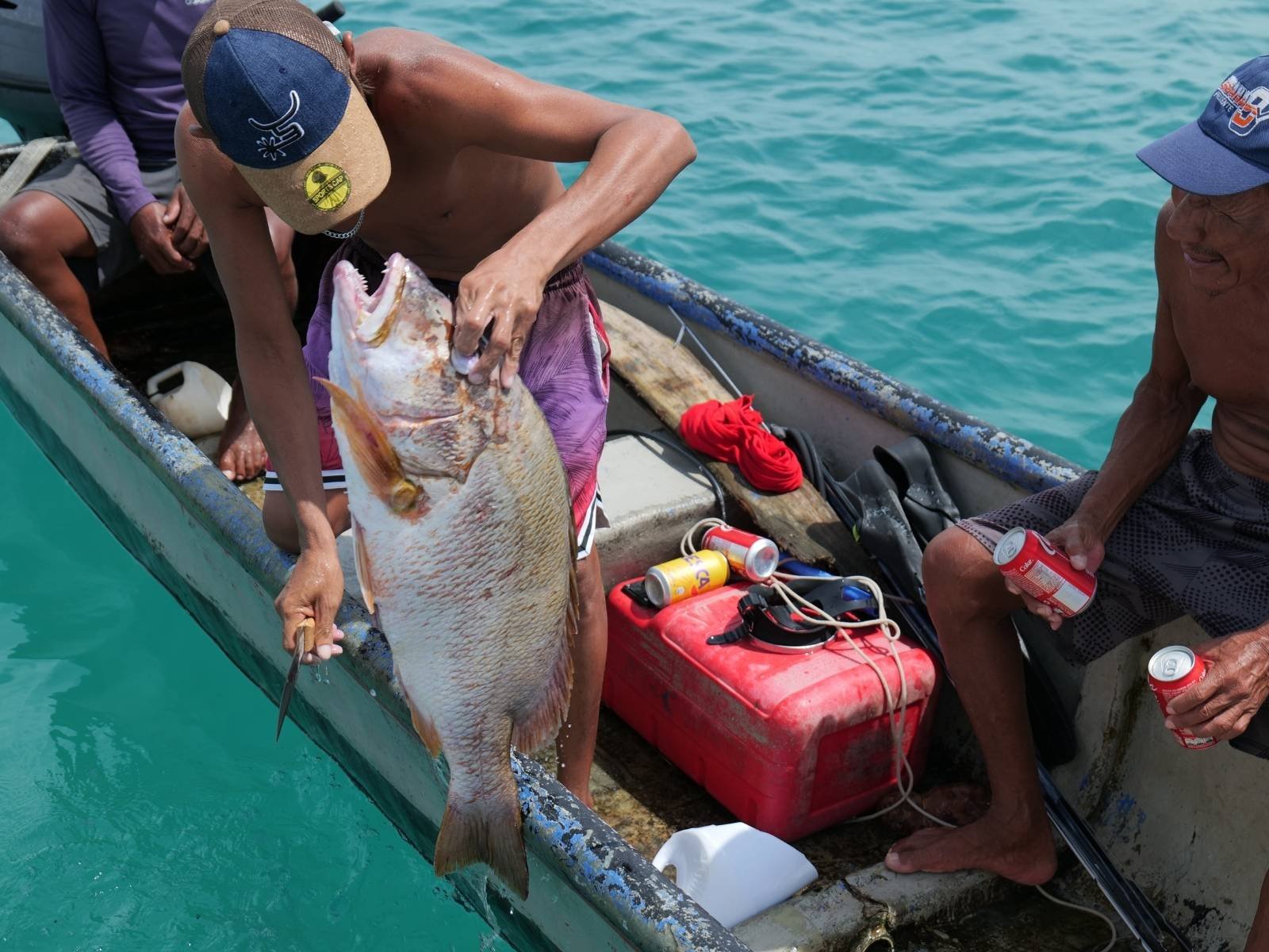 Guna fisherman selling fresh red snapper catch of the day in San Blas Islands Panama