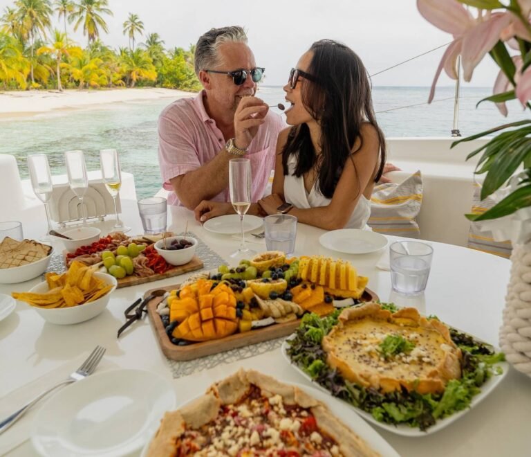 Couple enjoying a fresh meal together on catamaran deck in San Blas Islands Panama