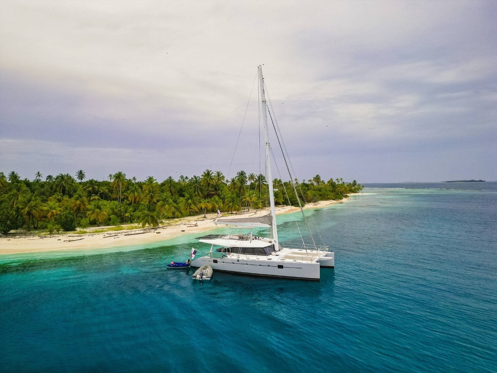 SunReef 62 catamaran anchored in turquoise waters of San Blas Islands