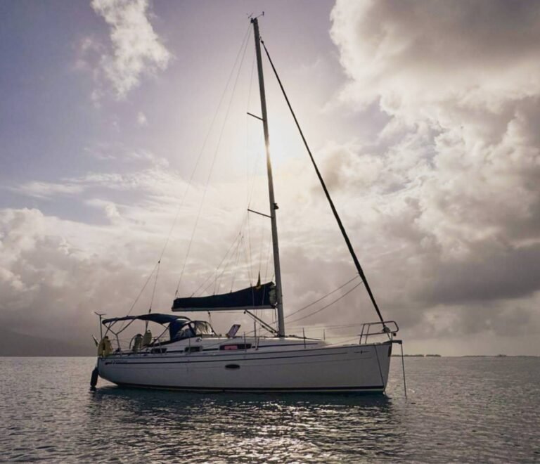 Bavaria 35 sailboat side view anchored in crystal clear waters of San Blas Islands Panama