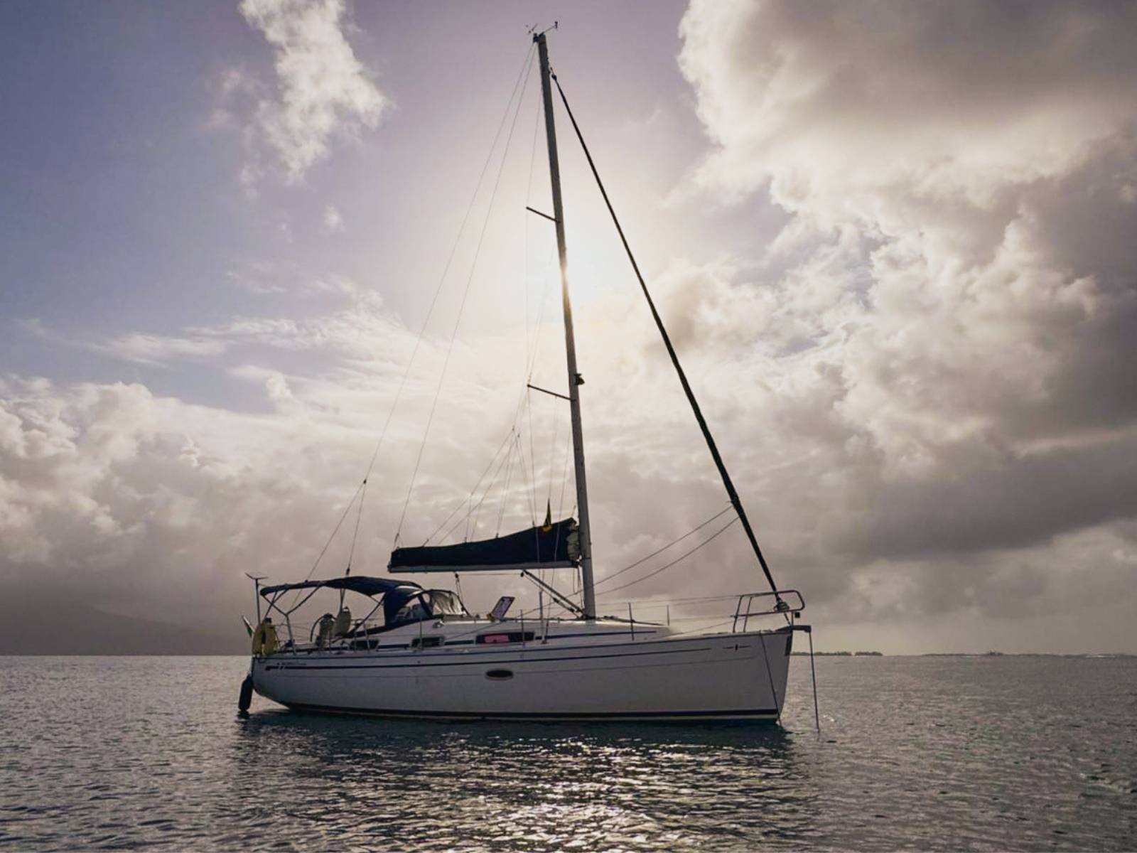 Bavaria 35 sailboat side view anchored in crystal clear waters of San Blas Islands Panama