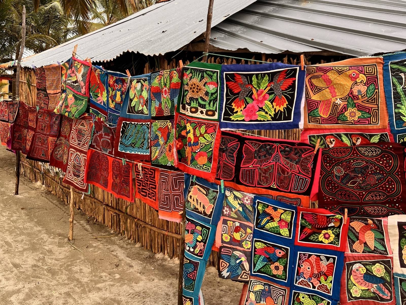 Guna women selling traditional mola textiles to tourists in San Blas Islands Panama