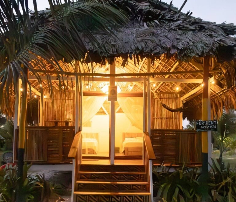Illuminated deluxe cabin exterior at night in Dutch Cays San Blas