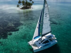 Lagoon 37 catamaran sailing in turquoise waters of San Blas aerial view