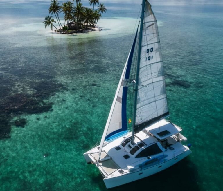 Lagoon 37 catamaran sailing in turquoise waters of San Blas aerial view