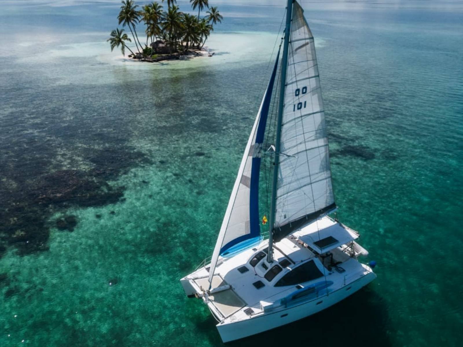 Lagoon 37 catamaran sailing in turquoise waters of San Blas aerial view