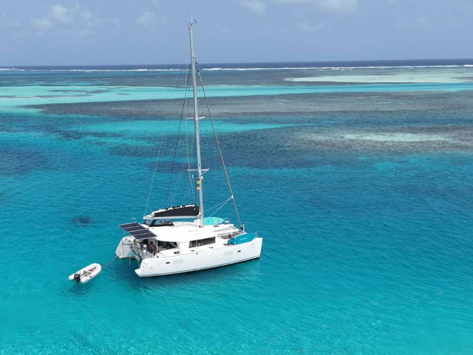 Lagoon 40 catamaran anchored in turquoise waters of San Blas Panama aerial view