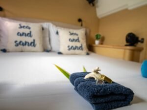 Private cabin bed inside Lagoon 440 catamaran in San Blas with decorative pillows