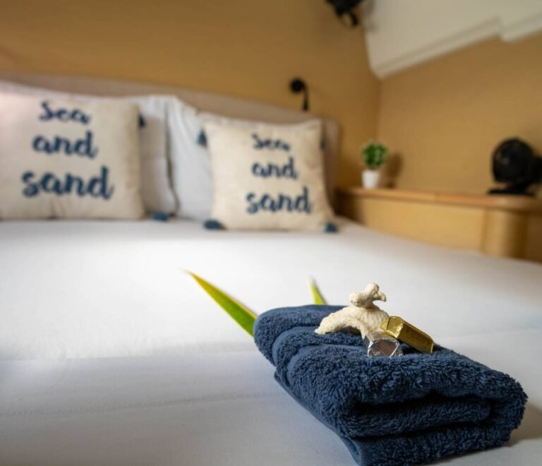 Private cabin bed inside Lagoon 440 catamaran in San Blas with decorative pillows