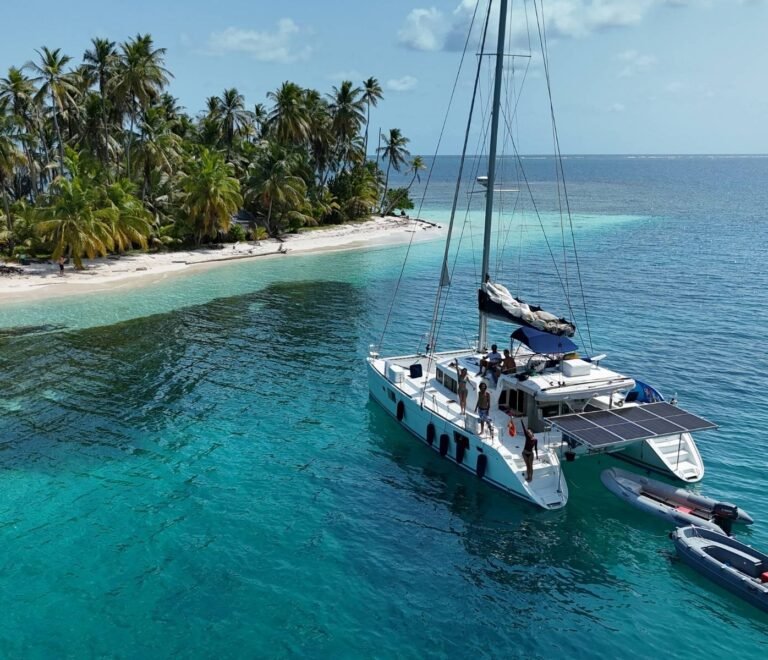Lagoon 440 catamaran anchored near tropical beach in San Blas aerial view