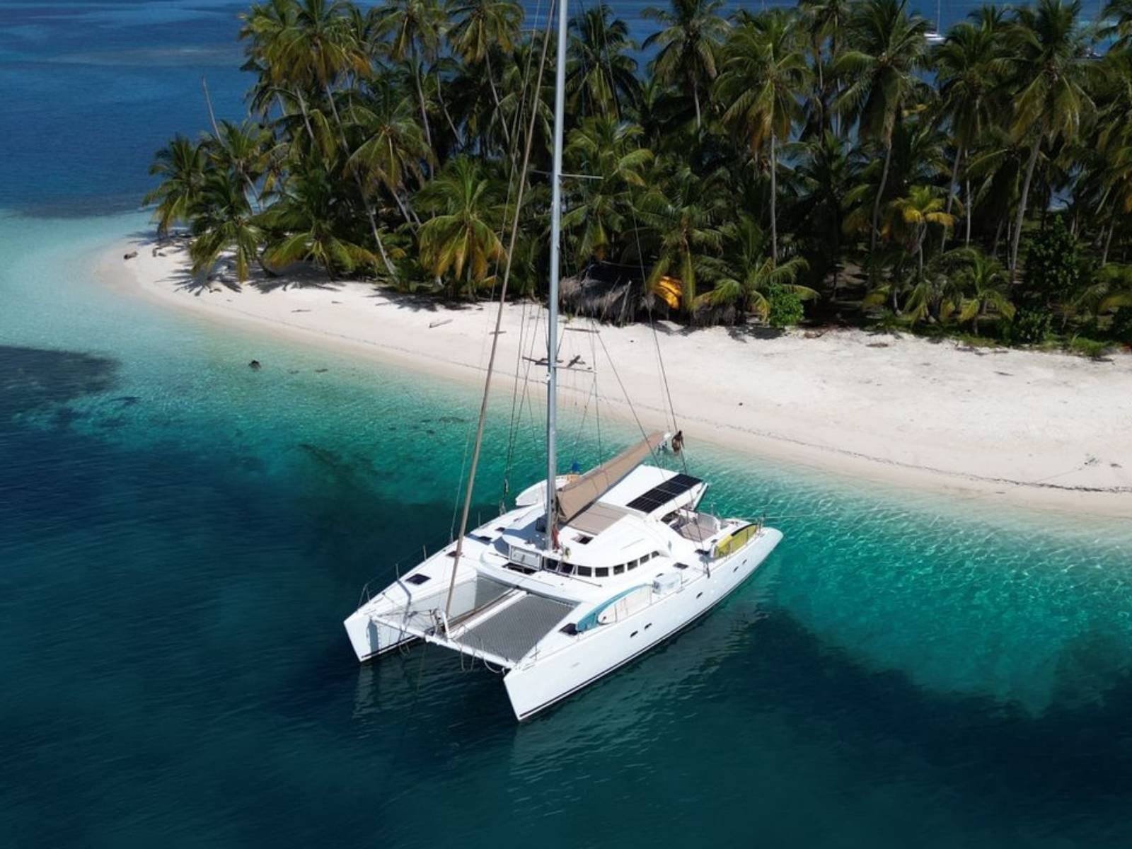 Lagoon 57 catamaran anchored near beach in San Blas aerial view