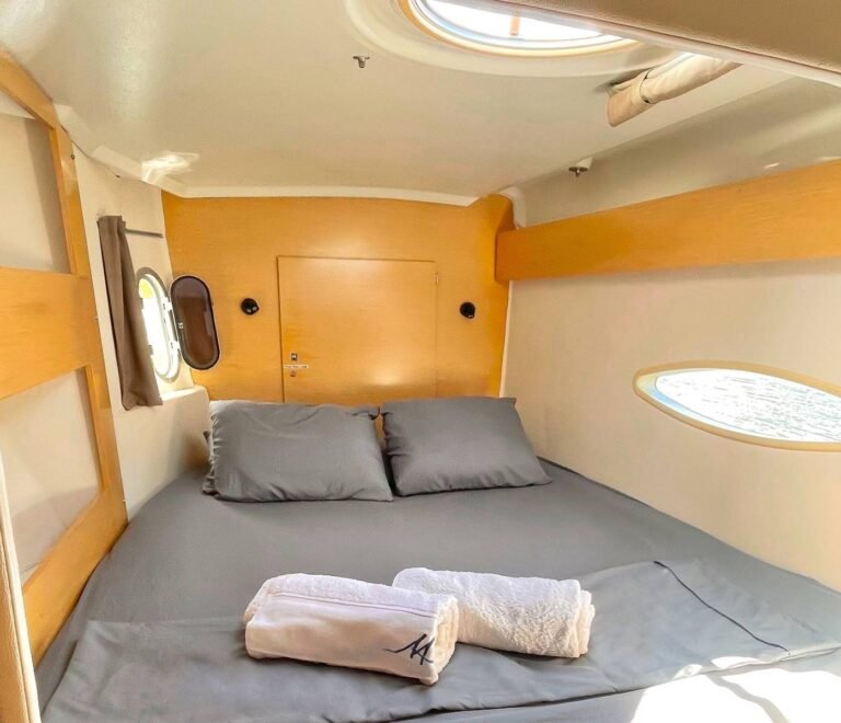 Cozy double cabin inside Lipari 41 catamaran in San Blas with side window