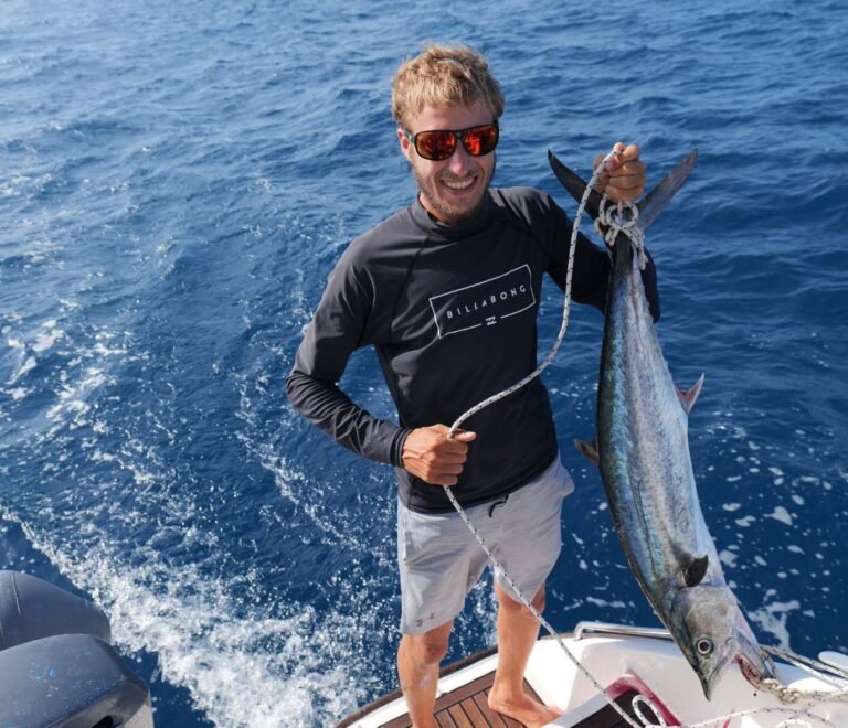 Captain fishing while sailing Lipari 41 catamaran in San Blas Panama