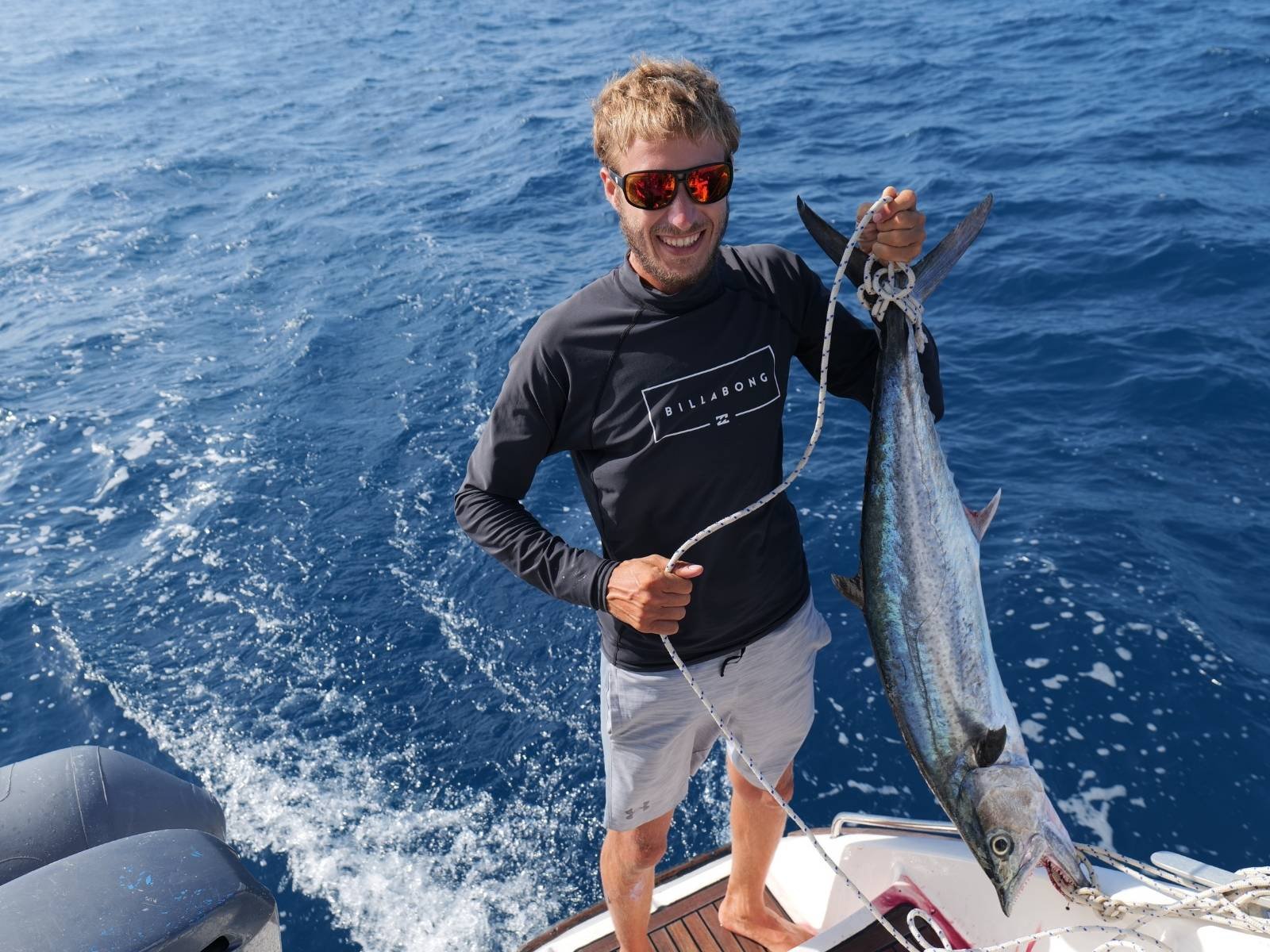 Captain fishing while sailing Lipari 41 catamaran in San Blas Panama