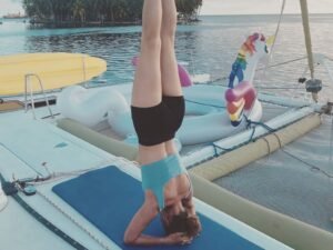 Guest doing yoga on Lagoon 55 catamaran deck in San Blas Panama