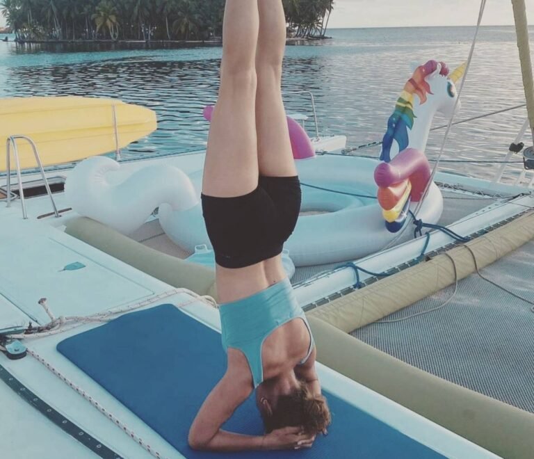 Guest doing yoga on Lagoon 55 catamaran deck in San Blas Panama