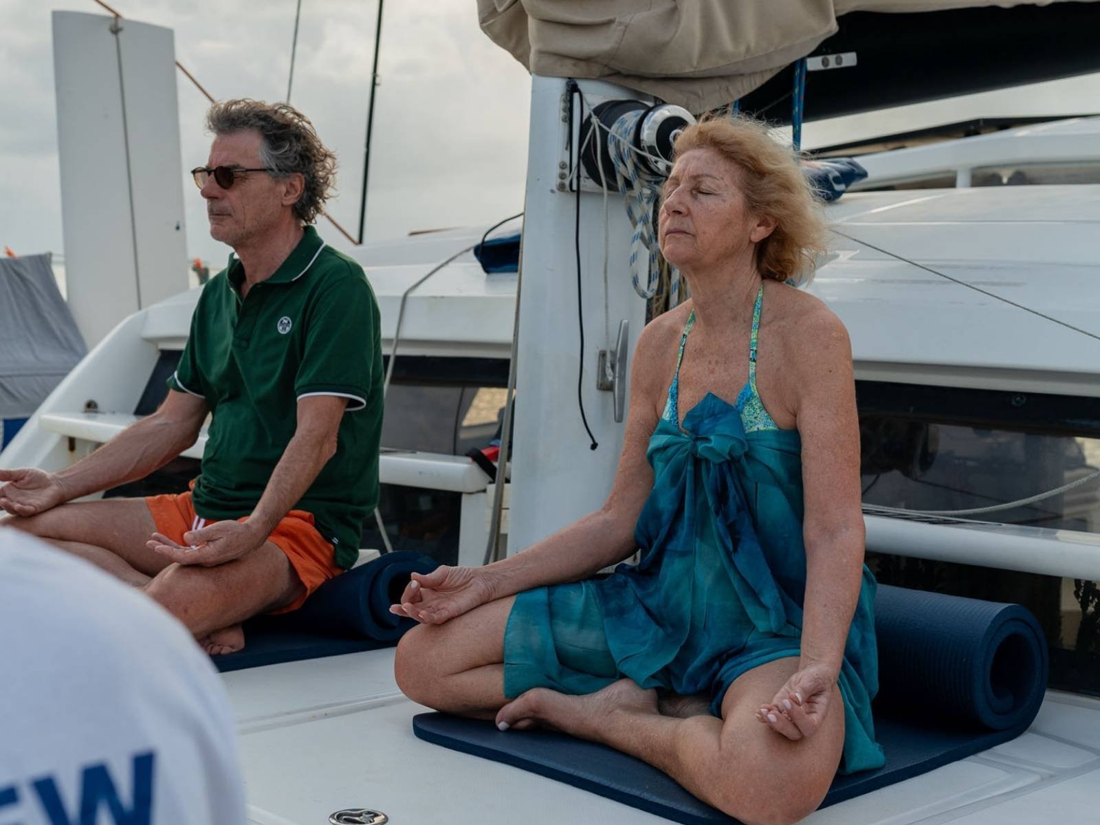 Guests meditating onboard catamaran wellness retreat in San Blas Panama