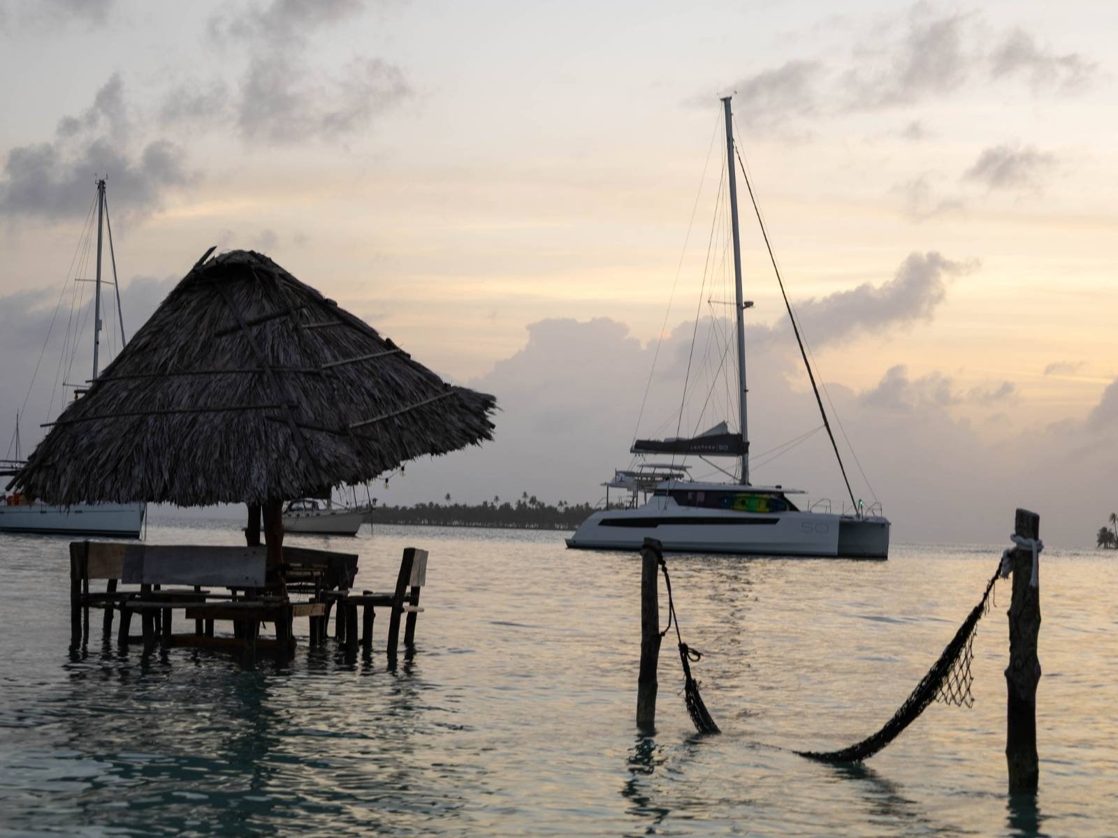 Hammock with catamaran view at sunset in Dutch Cays San Blas