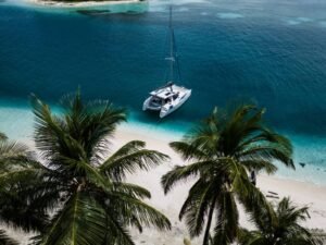 Lagoon 37 catamaran anchored in turquoise waters of San Blas aerial view