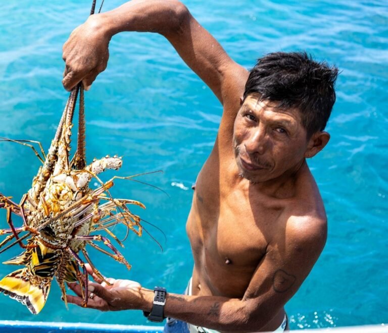 Local fisherman holding fresh lobster in San Blas Panama