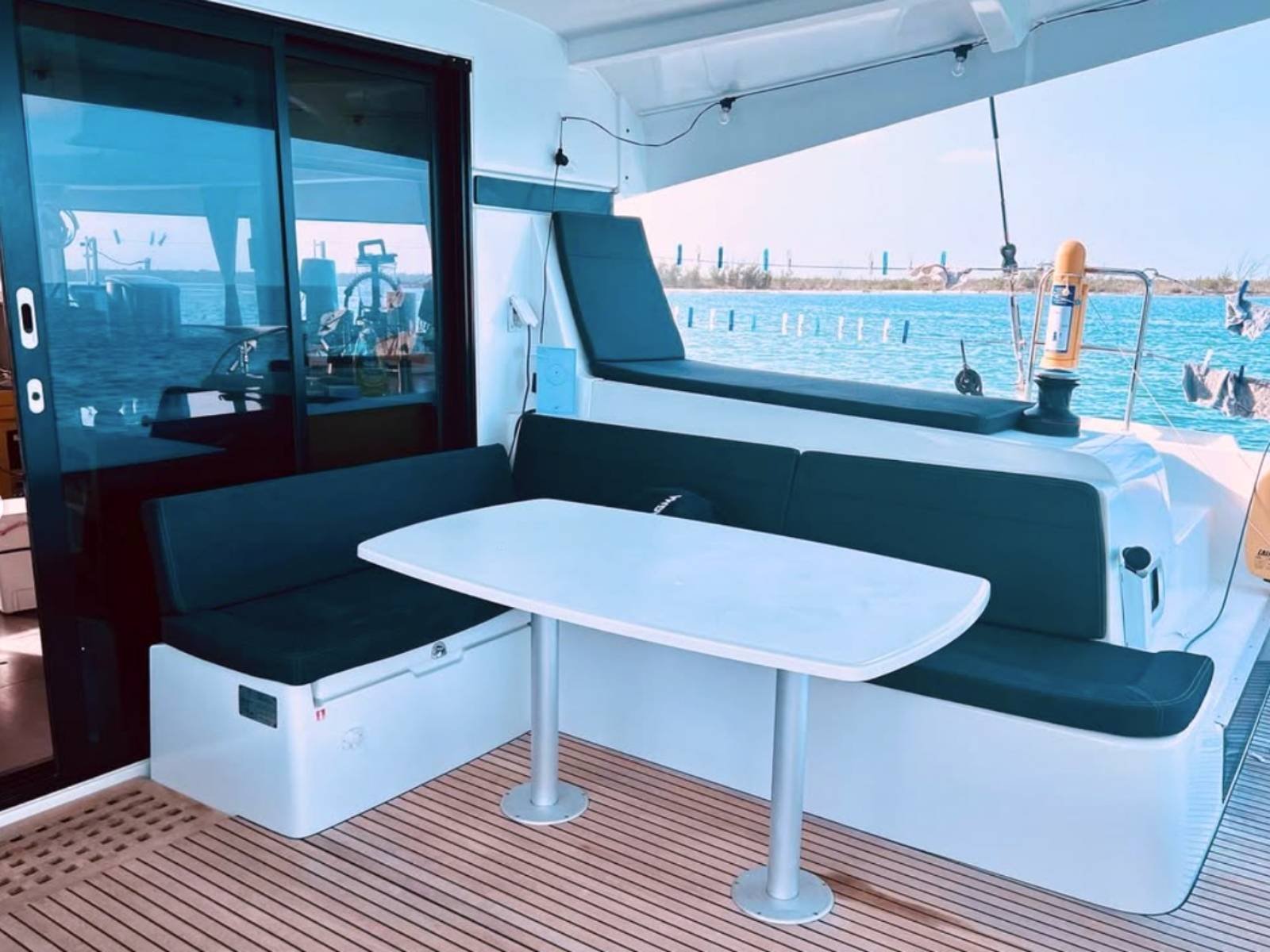 Outdoor cockpit dining area on Lagoon 42 catamaran in San Blas with sea views