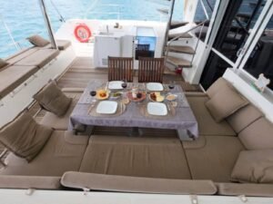 Outdoor dining cockpit on Lagoon 56 catamaran in San Blas with sea views