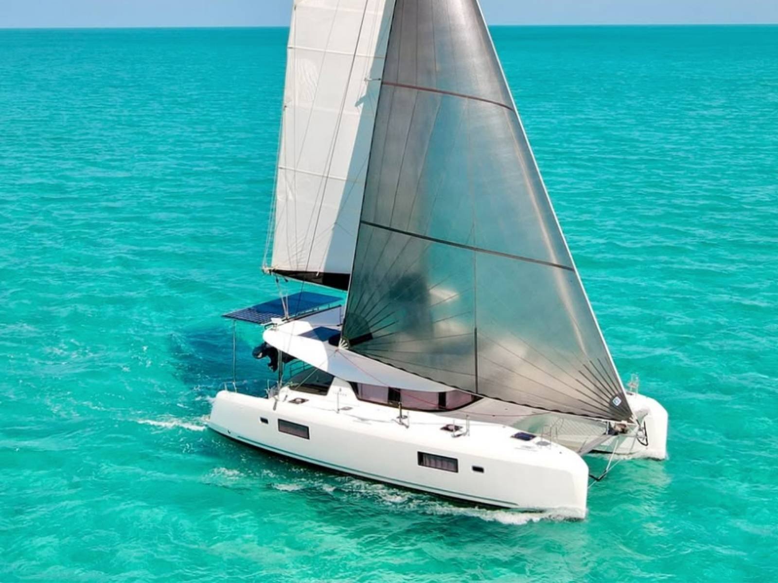 Lagoon 42 catamaran sailing in turquoise Caribbean waters of San Blas