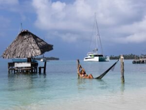 Hammock over the sea with catamaran view in Dutch Cays San Blas Panama