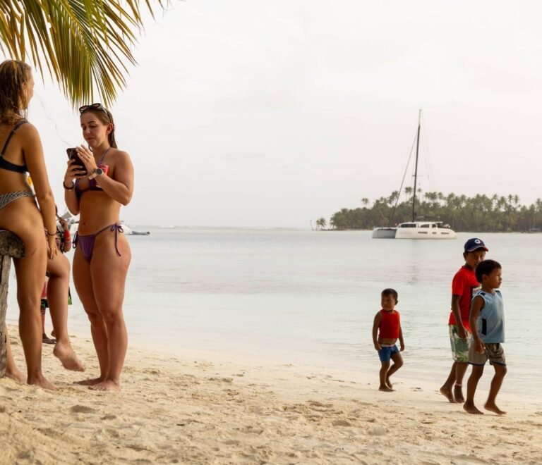 Familias y turistas en playa de Cayos Holandeses San Blas con niños disfrutando el mar Caribe