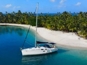 Bavaria 35 sailboat stern anchored next to a pristine tropical island in San Blas Panama